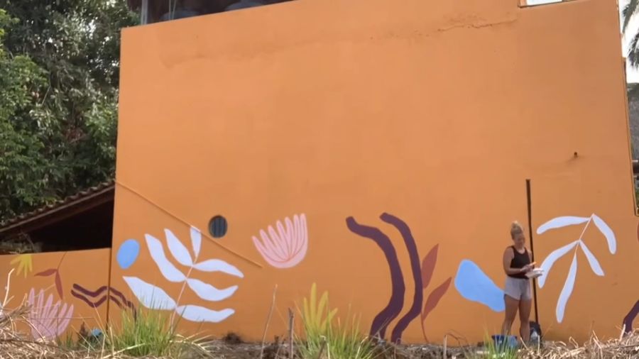 Finished orange exterior mural with white leaves and pink flowers — Scout Hill Co time-lapse
